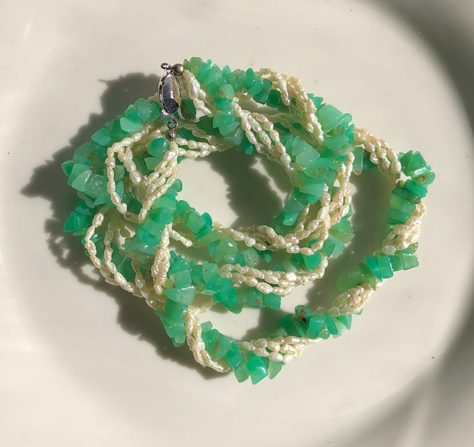 Green and Pearl Necklace: A beautiful necklace featuring green stones and pearls.