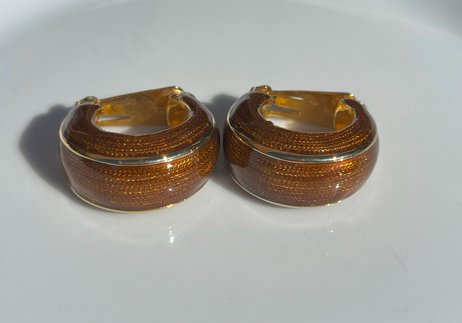 Gold Color Hoop Earrings: Elegant gold color hoop earrings with a textured design.