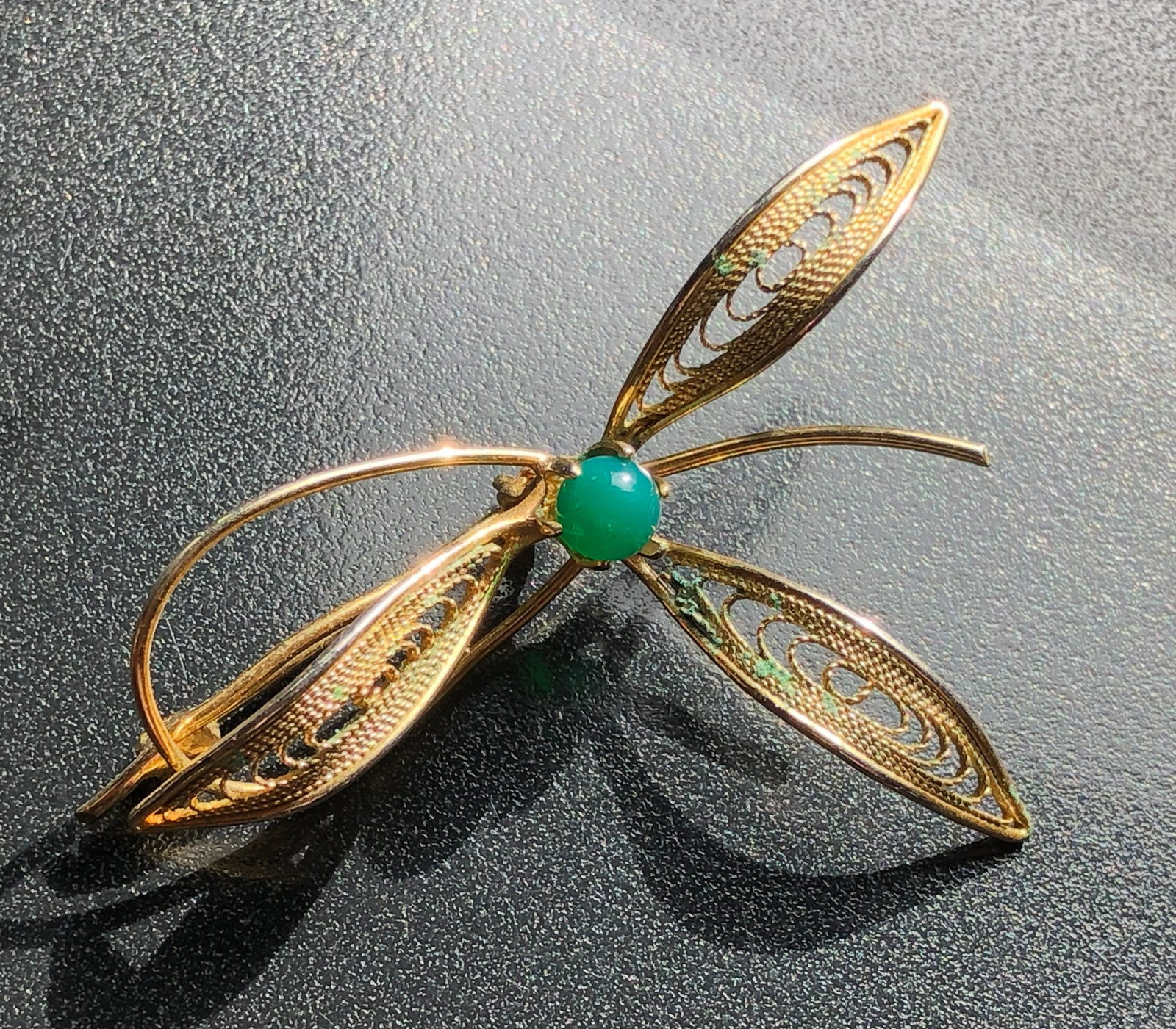 Gold Filled Filigree Brooch: Elegant gold filled filigree brooch with a green gemstone accent. Size: 2".