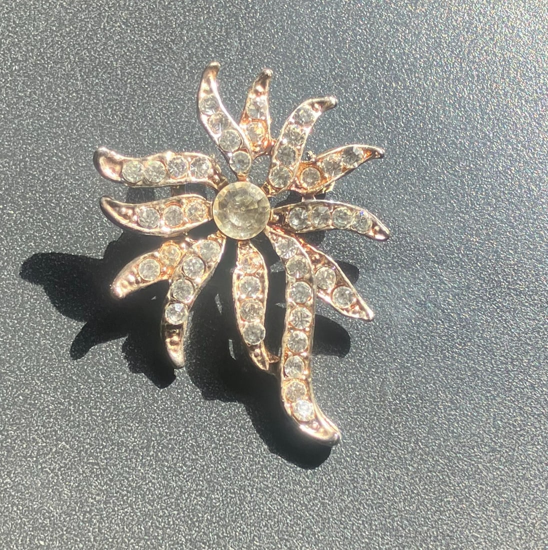 Crystal Flower Brooch: A sparkling crystal flower brooch with intricate design.