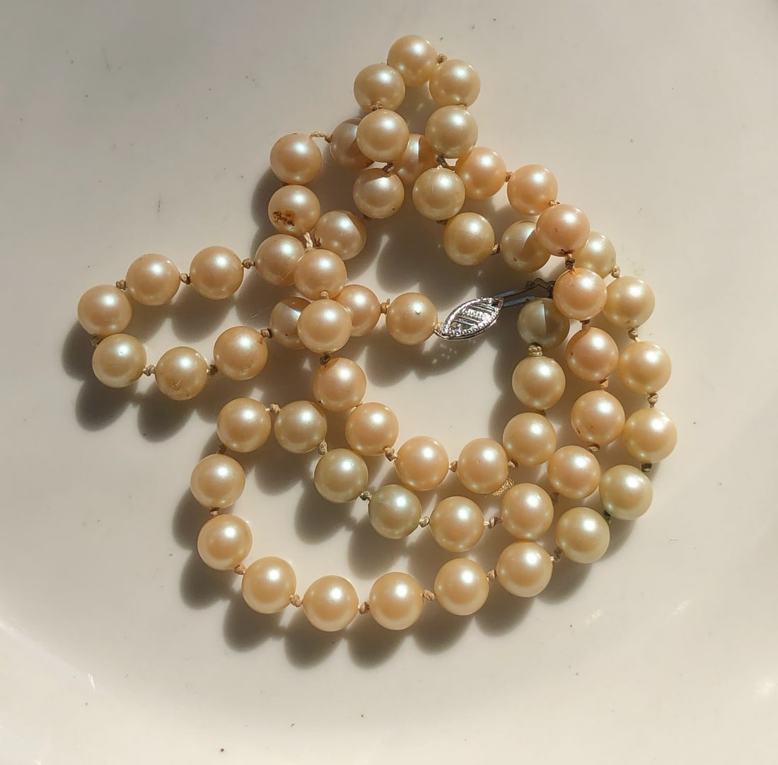 Faux Pearl Necklace: Elegant faux pearl necklace with a classic design.
