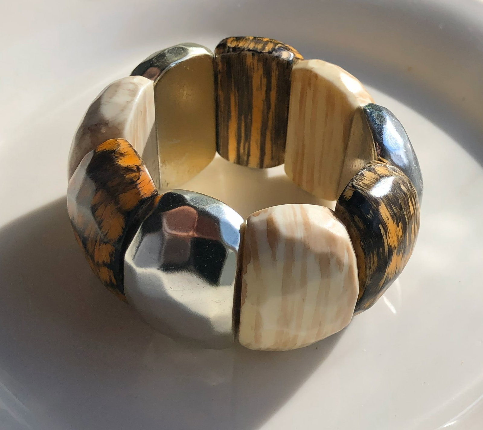Wood and Metal Bracelet: A stylish bracelet made of wood and metal segments.
