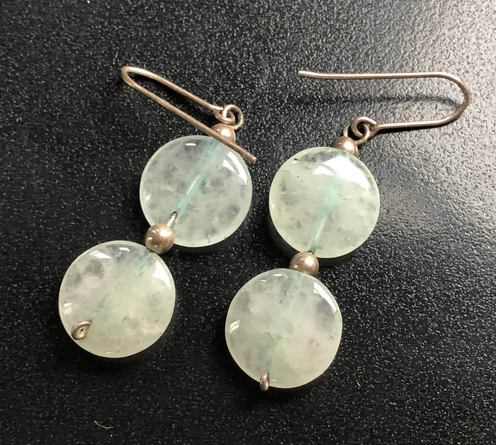 Aquamarine Earrings: Elegant aquamarine earrings with a simple hook design.