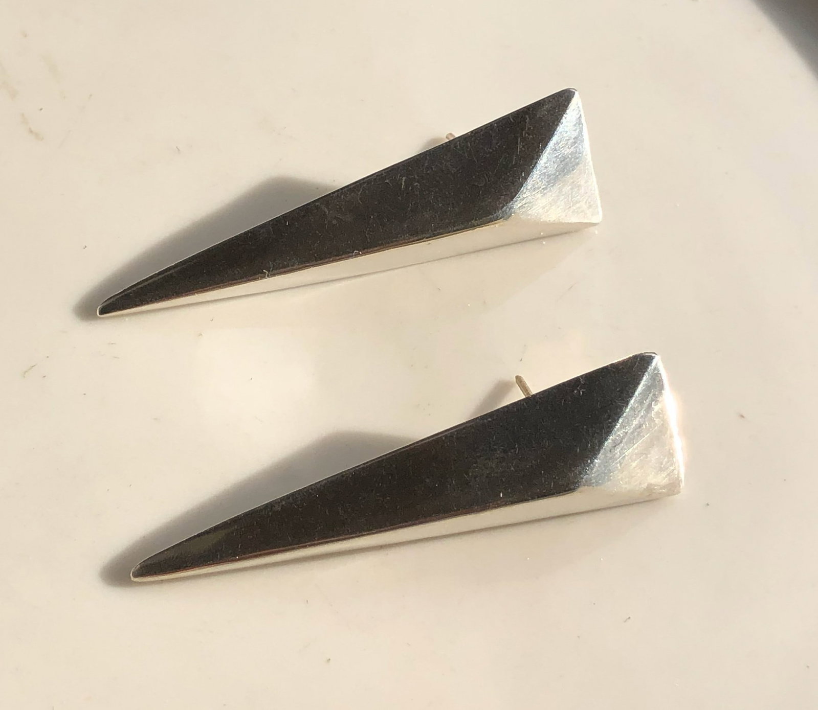 Silver Geometric Earrings: Elegant silver geometric earrings with a modern design. Size: 2.5"