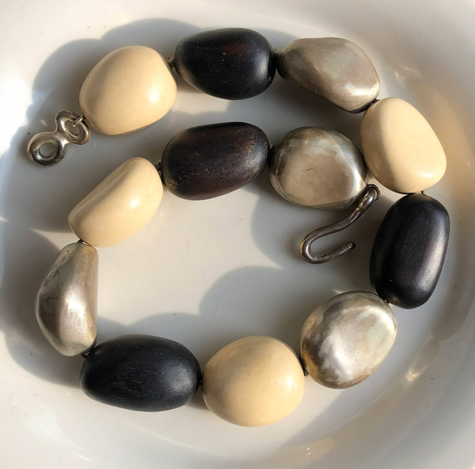 Chunky Bead Necklace: A stylish chunky bead necklace with a mix of black, cream, and metallic beads.