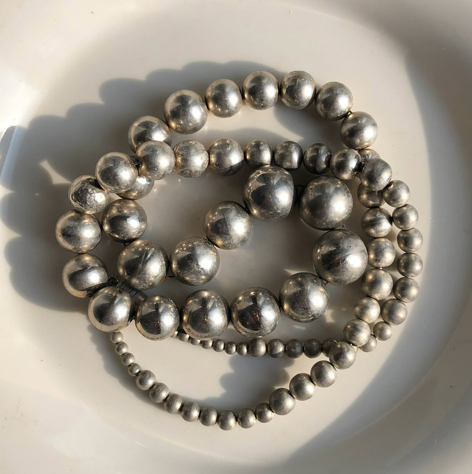 Silver Bead Necklace: Elegant silver bead necklace with a classic design.