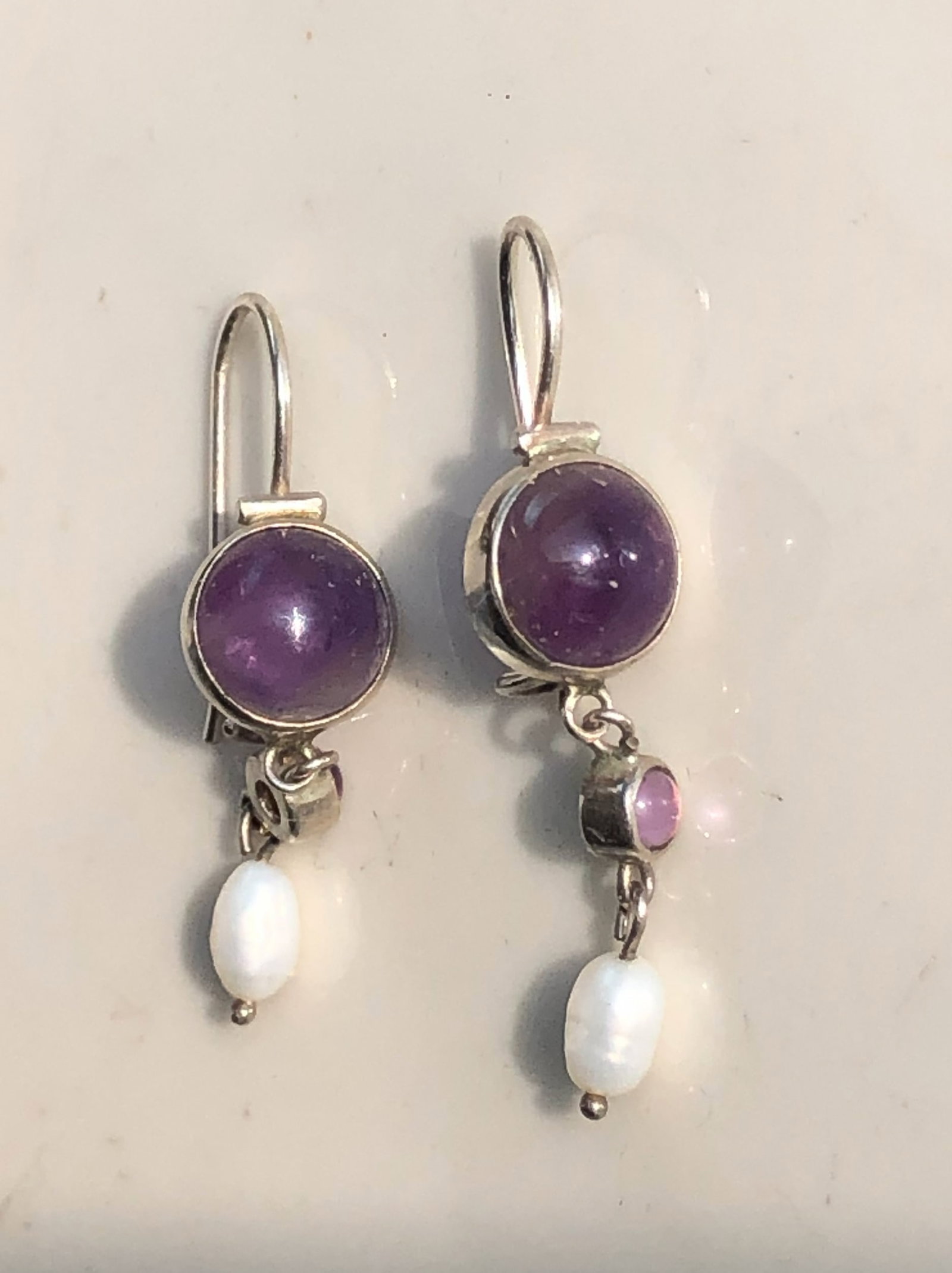 Amethyst and Pearl Silver Earrings: Elegant silver earrings featuring amethyst stones and pearl accents.