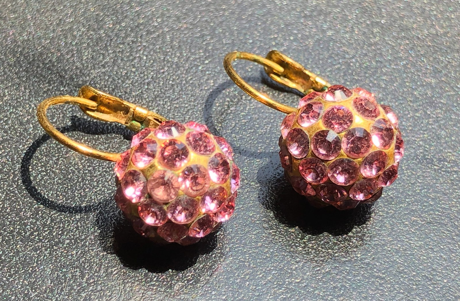 Elegant pink crystal earrings with a gold-tone finish. (1 of 2)