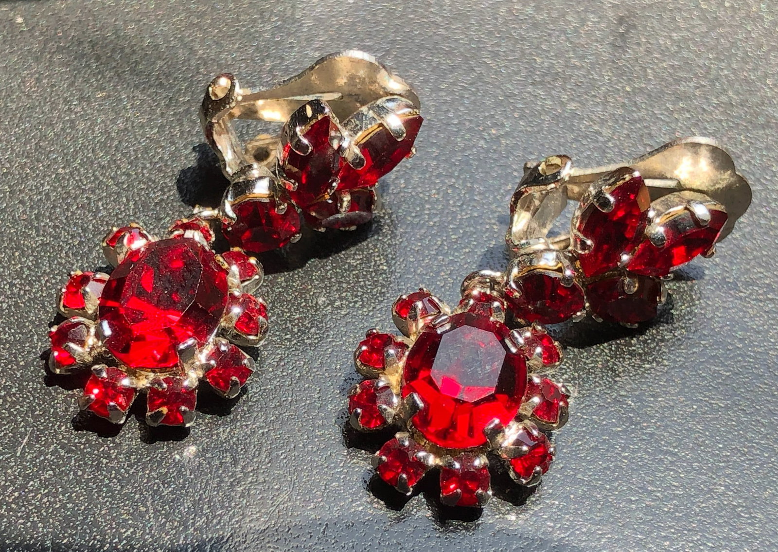 Elegant earrings featuring vibrant red stone set in a silver-tone metal (1 of 3)