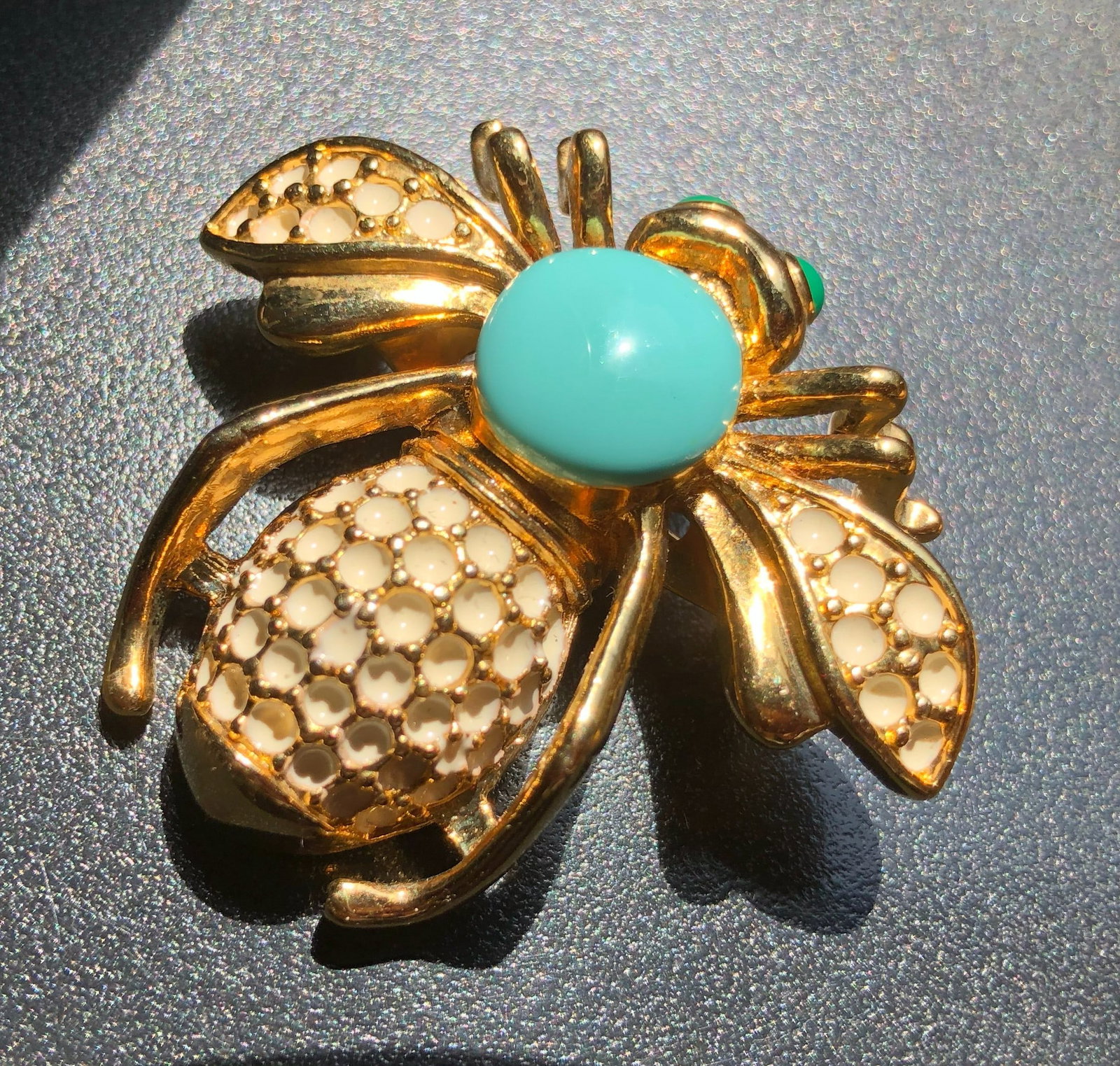 A stylish gold tone bee brooch with turquoise and white accents. (1 of 4)
