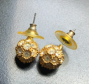 Elegant gold color stud earrings adorned with sparkling crystals