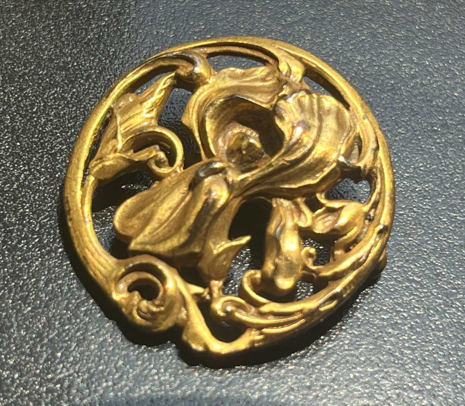 A beautifully crafted ornate gold filled brooch with intricate floral designs.: A beautifully crafted ornate gold filled brooch with intricate floral designs.