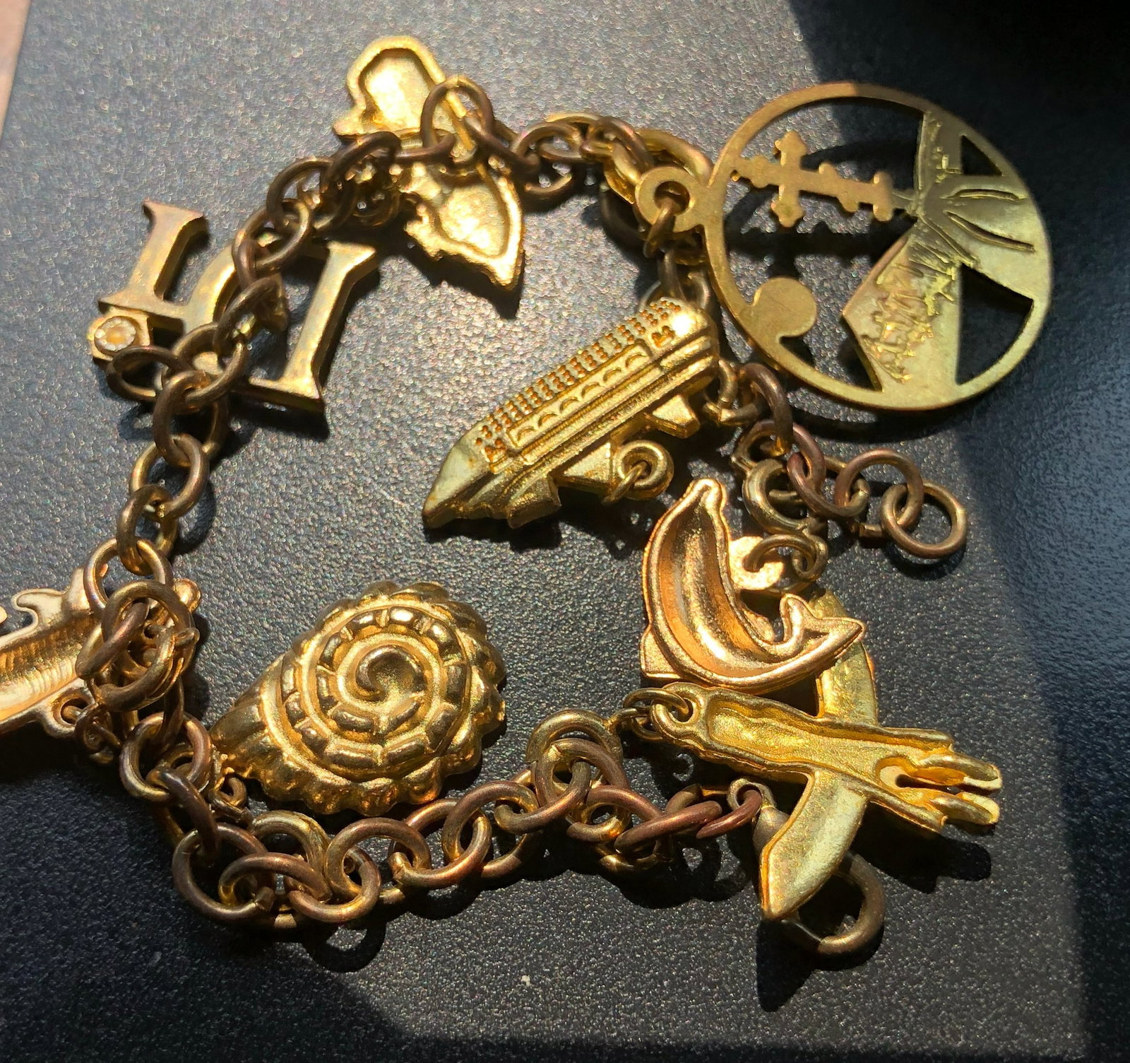 A unique vintage charm bracelet featuring various intricate charms (1 of 3)