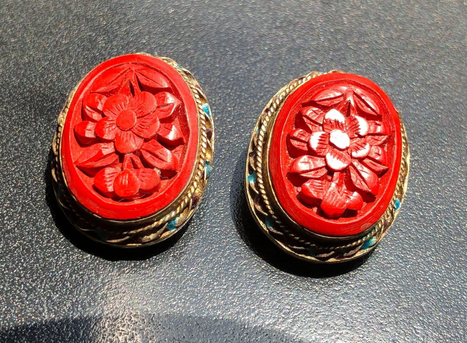 Beautifully carved cinnabar floral earrings with intricate details and vibrant colors.: Beautifully carved cinnabar floral earrings with intricate details and vibrant colors.