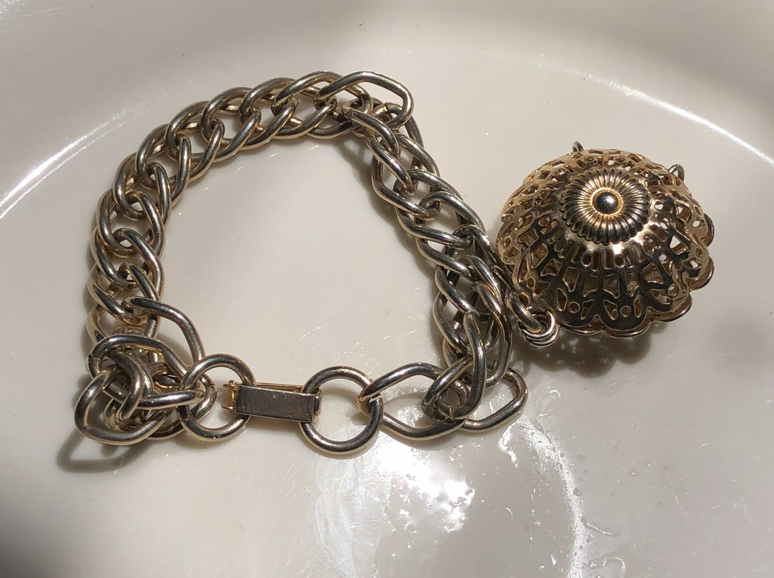 A stylish gold color chain bracelet with an intricate design