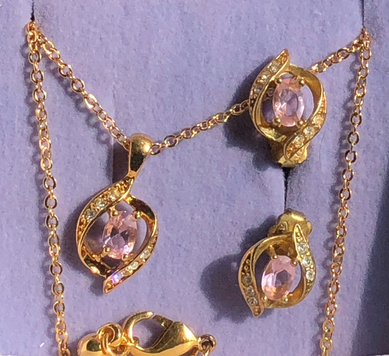 A beautiful gold plated jewelry set featuring pink gemstones and intricate design: A beautiful gold plated jewelry set featuring pink gemstones and intricate design