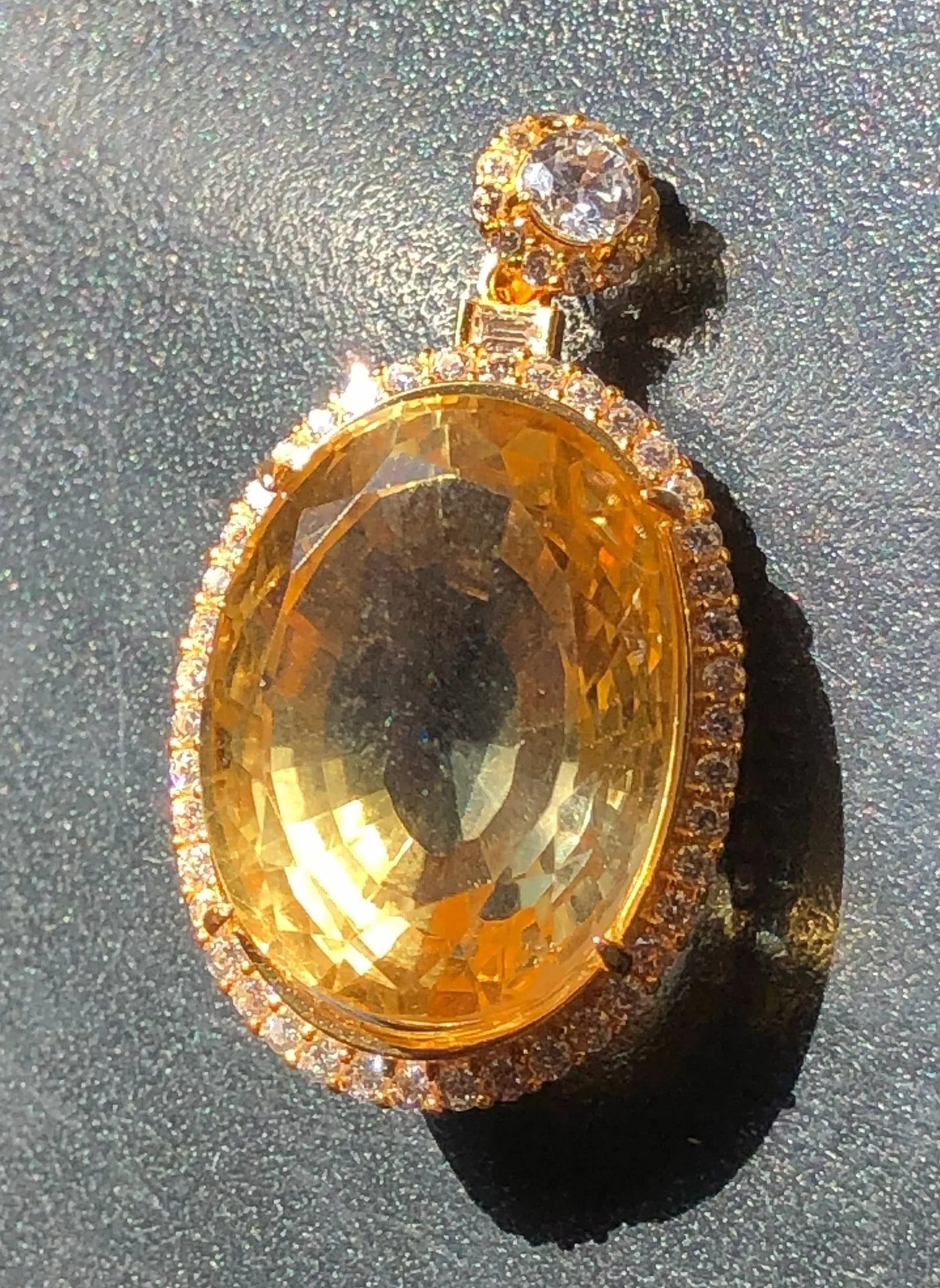 A stunning gold filled pendant featuring a large central citrine surrounded by fake diamonds