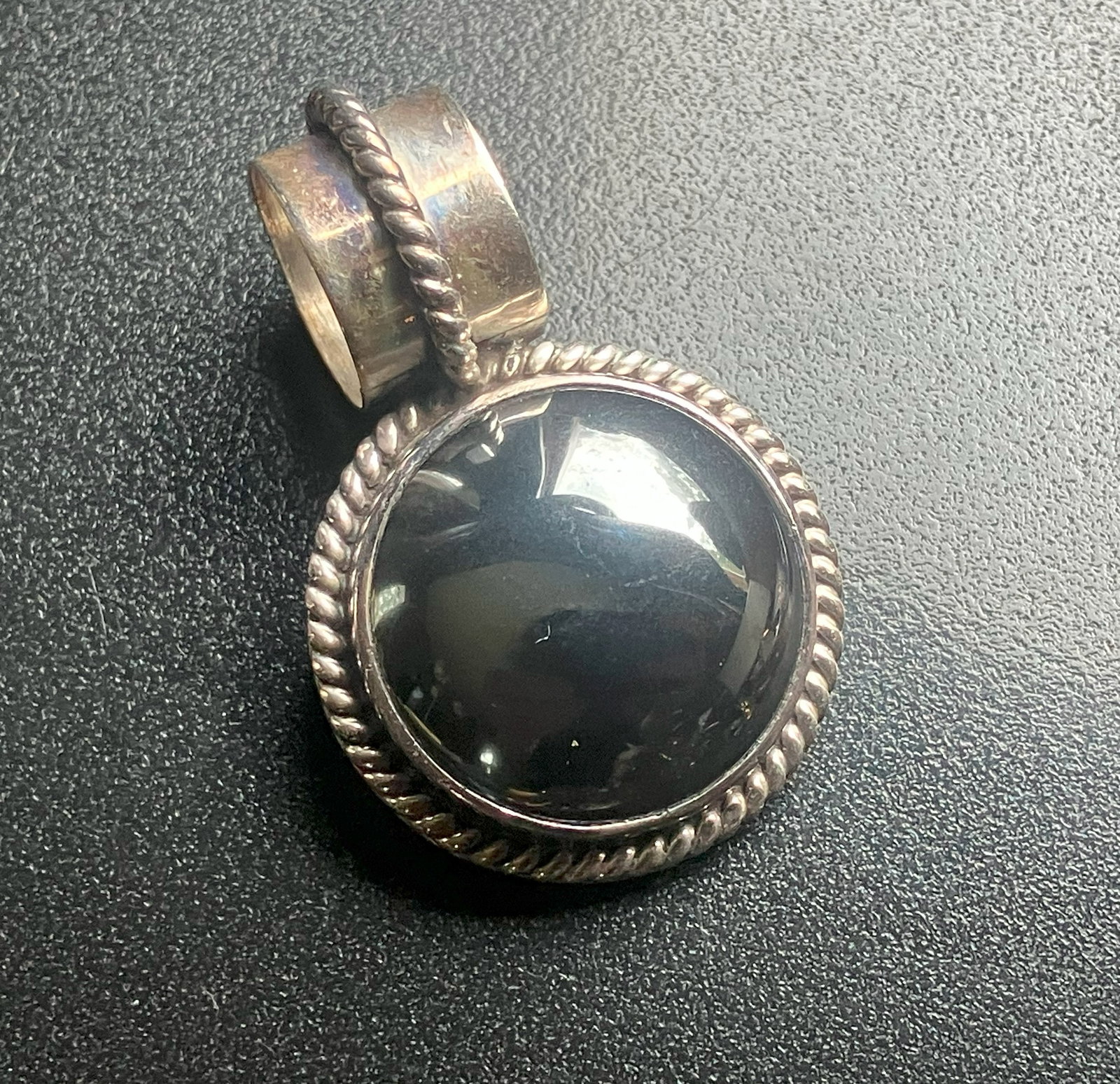 Silver Pendant: A beautifully crafted silver pendant with a polished stone centerpiece. Size: 1.5", weight 13.4g