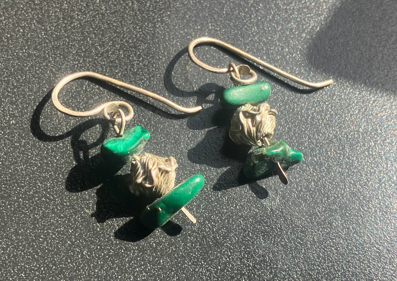 Green Stone Earrings: Elegant earrings featuring green stones and intricate metalwork.