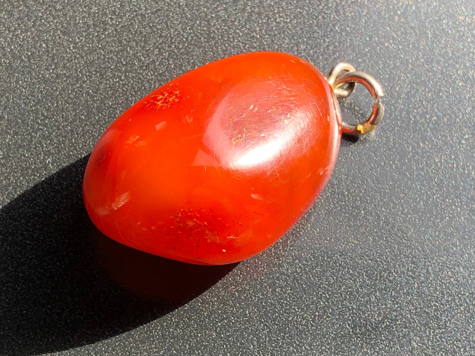 Amber Pendant: A beautiful Amber pendant with a smooth finish. Size: 1.5".