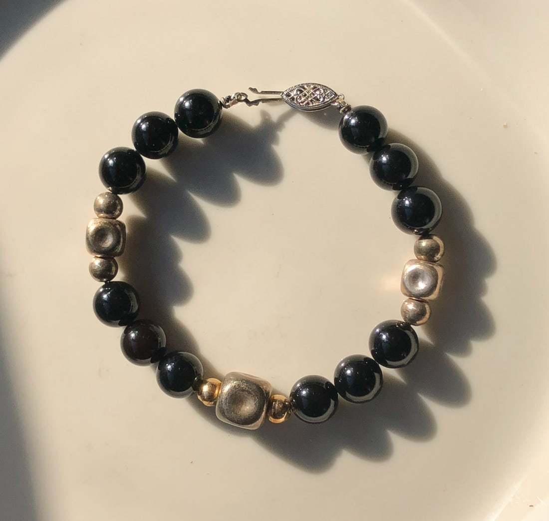 Elegant Beaded Bracelet: A stylish bracelet featuring black and metallic beads, perfect for any occasion.