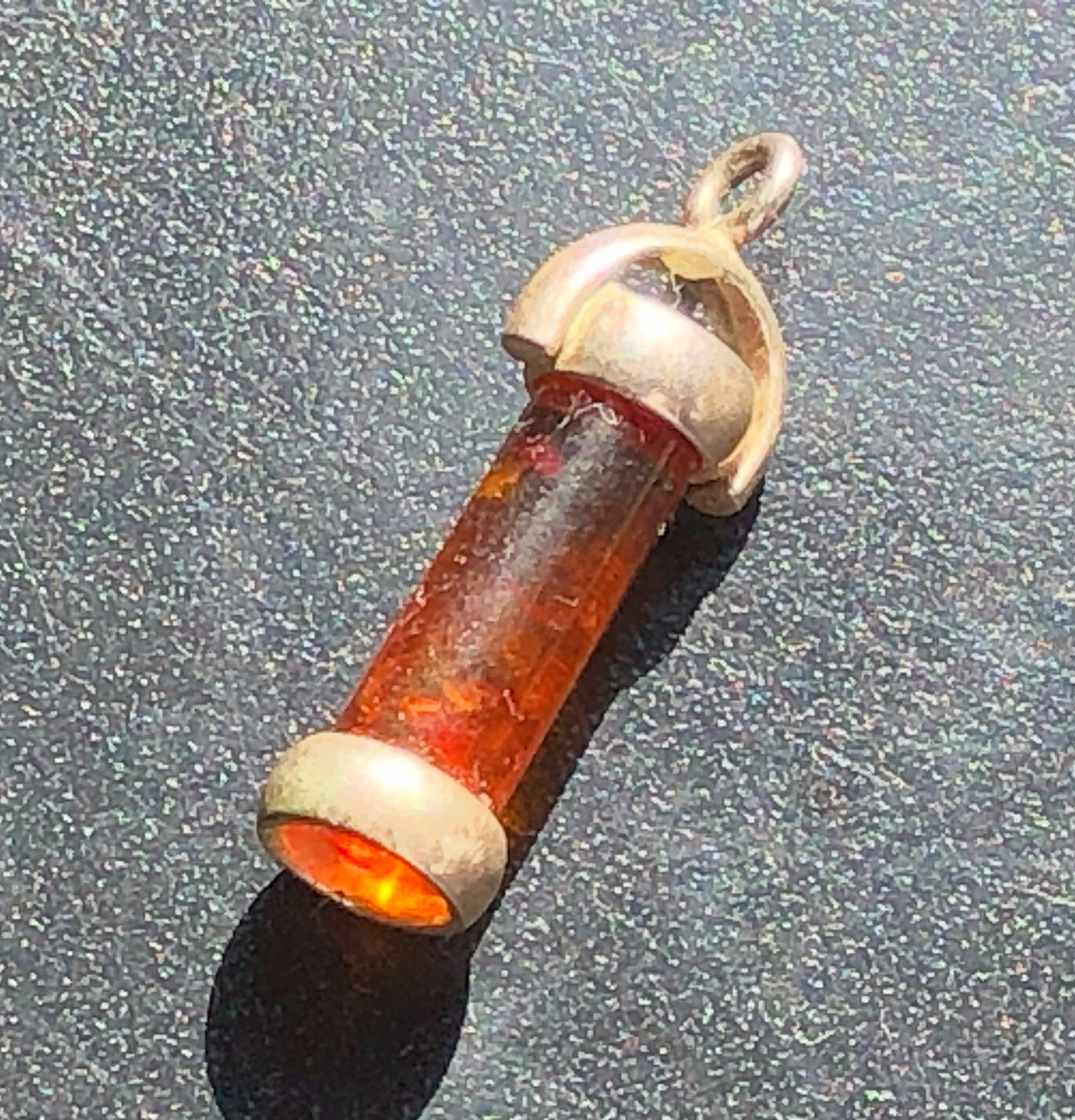 Silver Amber Cylinder Pendant: Elongated Silver pendant set with a translucent amber cylindrical insert between silver end caps and a curved bail