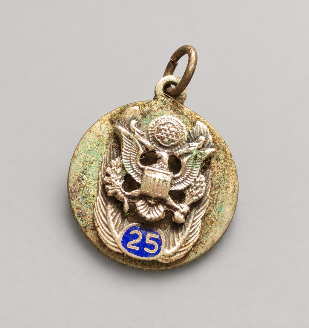 No. 25 U.S. Eagle Silver Pendant: A round Silver medal or charm featuring a raised United States eagle emblem and blue enamel number ?25,? and a reverse stamped ?U.S.S"