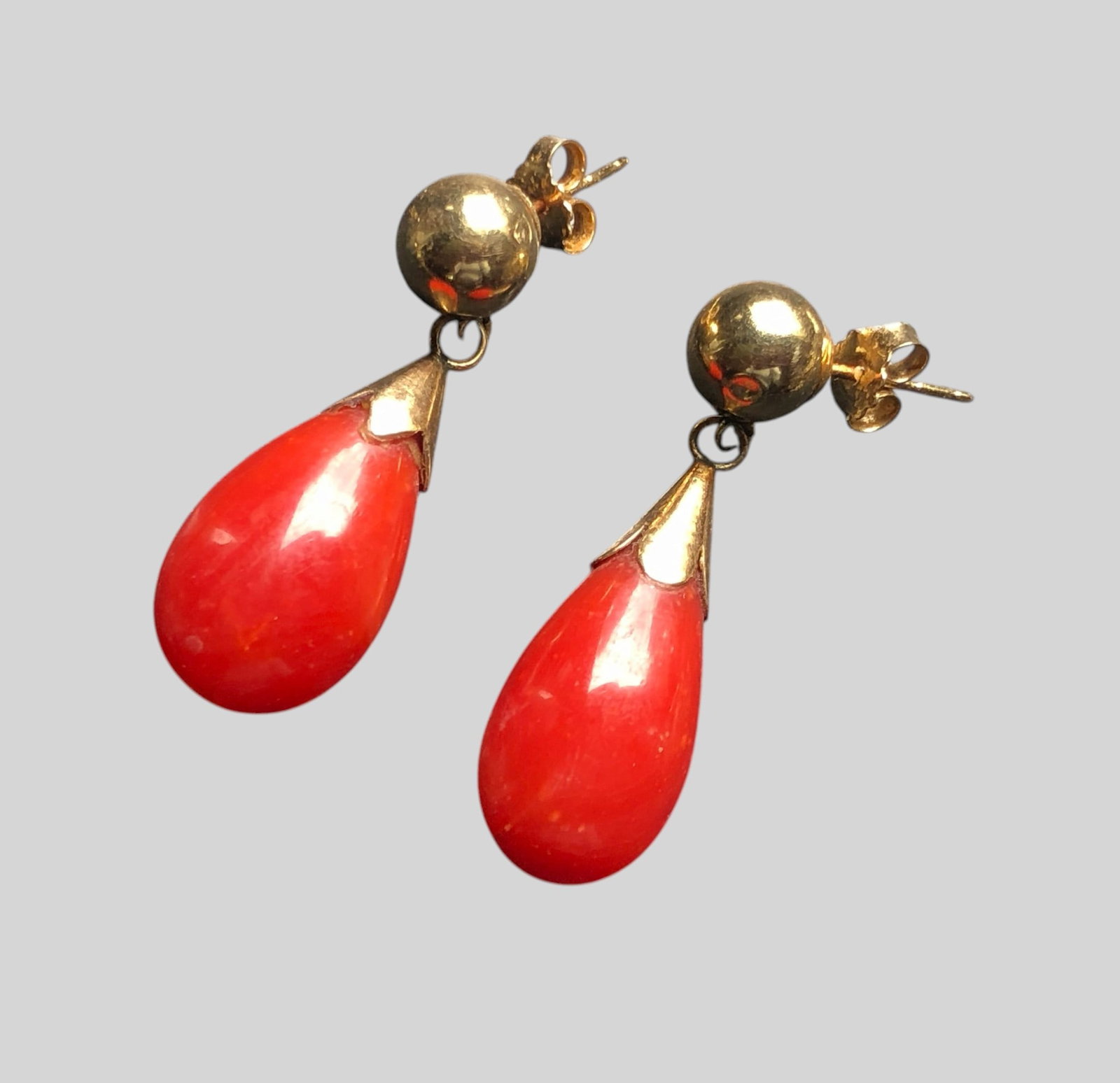 Pair of red Coral teardrop dangle earrings with 14K Gold bead tops and post fittings.: Pair of red Coral teardrop dangle earrings with 14K Gold bead tops and post fittings. Weight 4g.