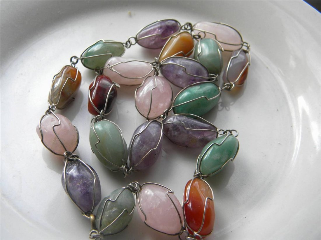 CHINESE JADE CARNELIAN AMETHYST NECKLACE SILVER WIRE: CHINESE CARNELIAN, AMETHYST, JADE AND OTHER STONE NECKLACE WITH SILVER WIR. THE BIGGEST STONE IS AROUND 1.1" LONG. TOTAL LENGTH AROUND 26".