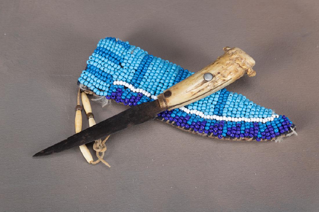 Early, hand made Skinning Knife with buck horn handle,: Early, hand made Skinning Knife with buck horn handle, blade measures 5 1/4" long, overall length 9 1/8". Accompanied by an old leather sheath covered with large multi-color beads.