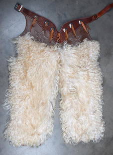 A pair of step in Angora Woolly Chaps in extra fine: A pair of step in Angora Woolly Chaps in extra fine condition marked "Axson Custom Leather" with spotted and basket weave belt. Chaps measure 36" long. KING COLLECTION