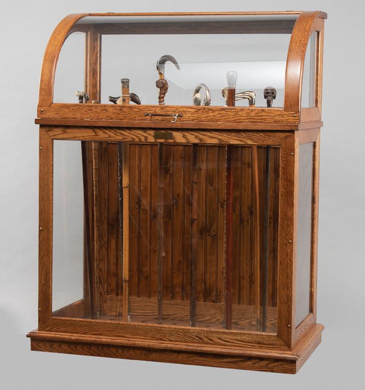 Fine condition antique curved glass and oak Cane &: Fine condition antique curved glass and oak Cane & Sword Display Case, factory label on front shows "Graver, Kaufman & Co., Manufacturers of Walking Sticks, Umbrellas, Parasols, Cleveland, Ohio.", cir