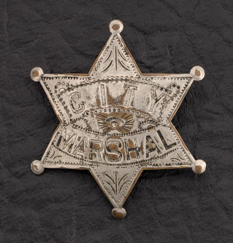 City Marshal Badge, 6 point ball star, 2 1/2" across: City Marshal Badge, 6 point ball star, 2 1/2" across points, engraving around edges of star, at points and in center, turn of the century. GEORGE JACKSON ESTATE