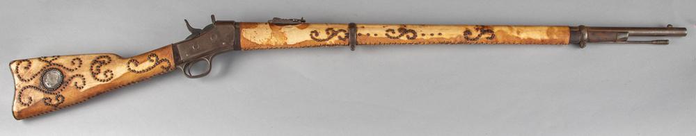 Early Remington Rolling Block Rifle, circa 1867-1888,: Early Remington Rolling Block Rifle, circa 1867-1888, 34" barrel with two barrel bands, rawhide wrapped and brass spotted tacks on stock and forend, with what appears to be inlaid 1883 silver dollar i