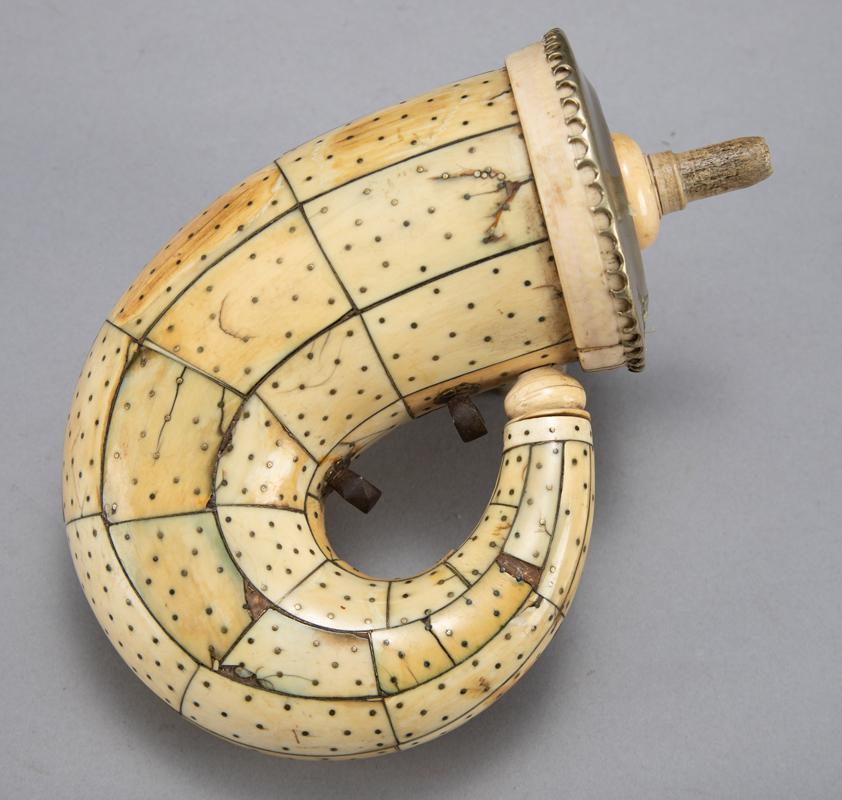 Vintage polished bone Powder Flask, showing a few use: Vintage polished bone Powder Flask, showing a few use chips, has removable powder tip and silver cap. Measures approximately 6" long with additional 5" curve, 3 1/4" diameter.