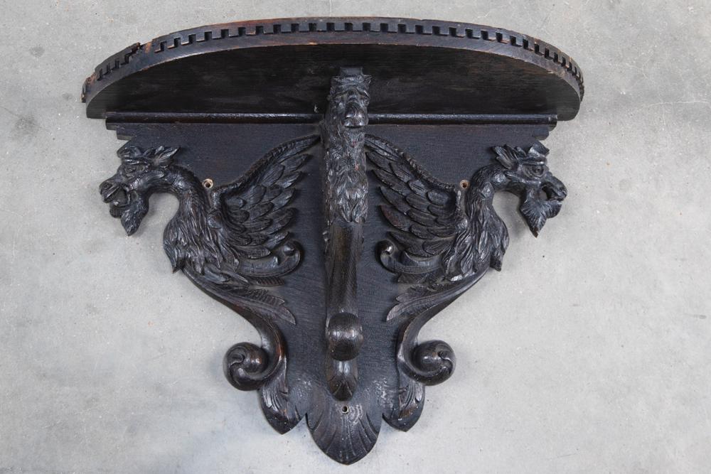 Very ornate antique carved oak hanging wall Shelf with: Very ornate antique carved oak hanging wall Shelf with carved winged lion supporting shelf, trim work on outside edge with some trim missing, original finish. CROWDER ESTATE.