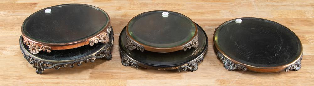 This lot will consist of a collection of five vintage: This lot will consist of a collection of five vintage Plateau Mirrors on footed bases. One measures 11 1/4" diameter x 2" tall. Three measure 11" diameter x 1 1/4" tall. One measures 8" diameter x 1 1