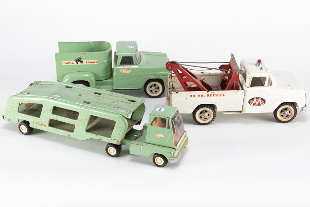 This lot consists of three vintage tin Tonka Toys to: This lot consists of three vintage tin Tonka Toys to include: (1) Tonka Truck marked "Tonka Farms", 12 1/2" long x 5 1/4" tall x 5 1/2" wide. (2) Tonka Wrecker, 14" long x 6" tall x 5 1/2" wide. (3) T
