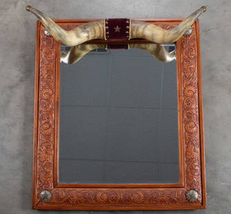 Fancy carved wooden hanging Mirror with steer horn: Fancy carved wooden hanging Mirror with steer horn crest. Horns measure 25" wide with brass tips and silver star marked "TEXAS" in center, actual frame measures 25" wide x 28" long.