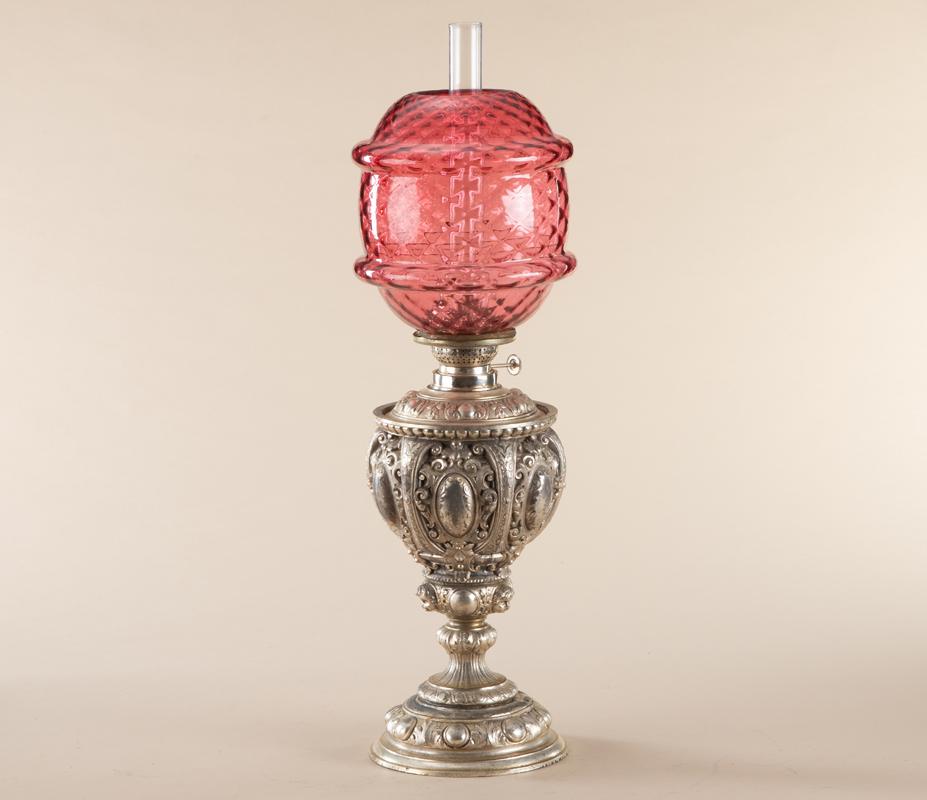 Antique Oil Lamp with heavily embossed base and font: Antique Oil Lamp with heavily embossed base and font with nickel silver finish (some finish peeling at base), marked "Rundbrenner", appears to be in original condition. Lamp has an unusual quilted 7" 