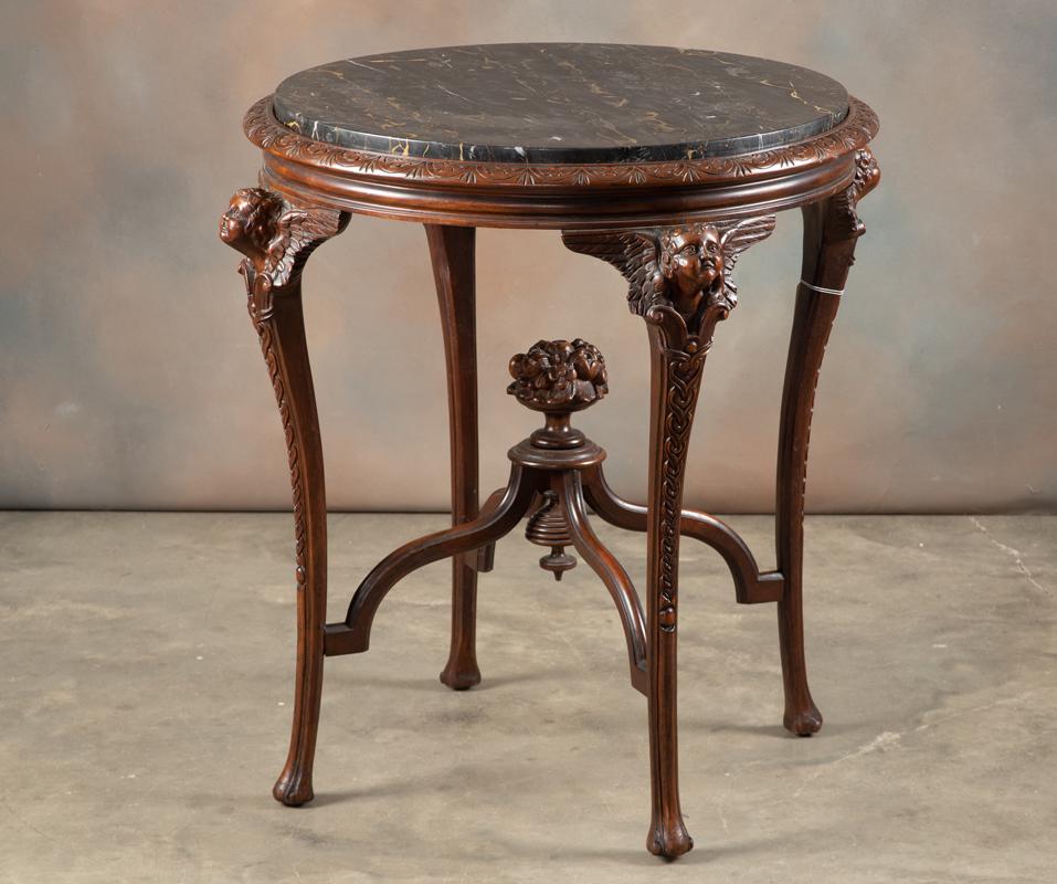 Beautiful antique mahogany Lamp Table, circa 1900-1910,: Beautiful antique mahogany Lamp Table, circa 1900-1910, with original marble insert top, carved winged cherubs on cabriole legs, full carved basket of fruit in center of stretcher. Original finish, ex