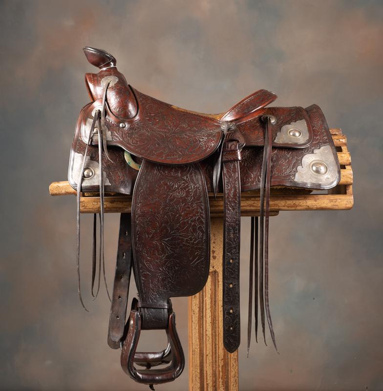ATTENTION COLLECTORS OF HOLLYWOOD MEMORABILIA:: ATTENTION COLLECTORS OF HOLLYWOOD MEMORABILIA: Fancy floral tooled, brown two-tone Saddle once owned by Hollywood actor Ward Bond, marked "Olsen-Nolte / Maker / San Francisco, Calif.", 16" seat, 2 1/2