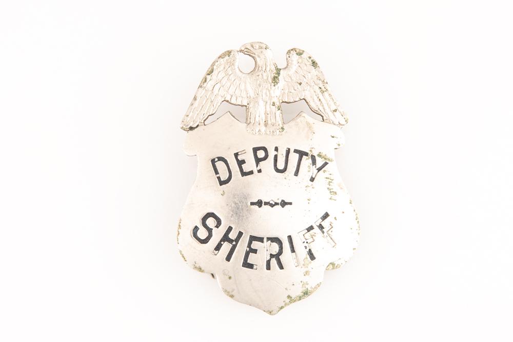 Deputy Sheriff Badge, shield with eagle crest, 2 1/4": Deputy Sheriff Badge, shield with eagle crest, 2 1/4" tall x 1 1/2" wide, hallmark "Ed Jones & Co,. Oakland". GEORGE JACKSON ESTATE