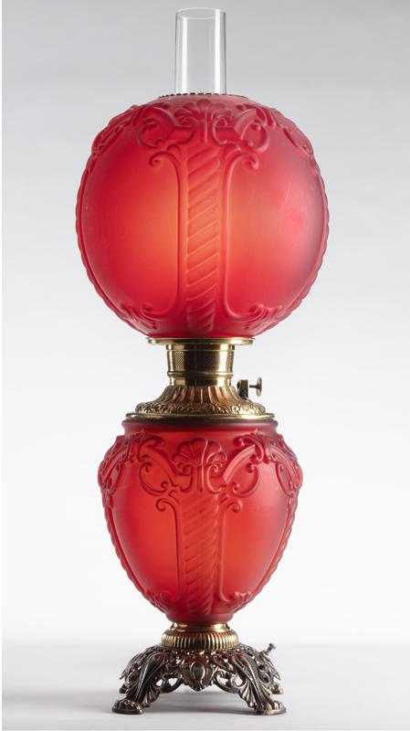 Unusual red Victorian Gone With the Wind Lamp with: Unusual red Victorian Gone With the Wind Lamp with embossed 10" shade and matching base, embossed brass font and fancy embossed brass footed base. Has been converted from oil to electric with lighted