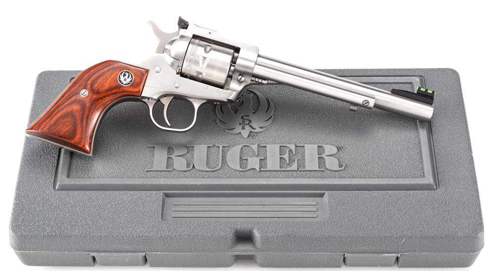 Like new in box Ruger, Single Nine, nine shot Single: Like new in box Ruger, Single Nine, nine shot Single Action Revolver, .22 WIN MAG caliber, SN 815-08591, stainless finish, 6 1/2" barrel, fancy wooden grips with Black Hawk Medallions, lighted front s