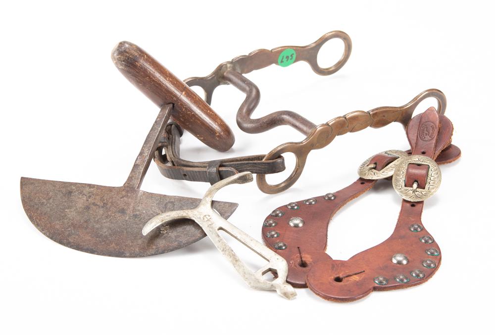 This lot consists of four items to include: (1) A heavy: This lot consists of four items to include: (1) A heavy brass Bit. (2) Hand forged leather Cutter. (3) "Anchor" marked Hoof Cleaner. (4) A pair of two-piece spotted Straps marked "Cowboy Design". Thes