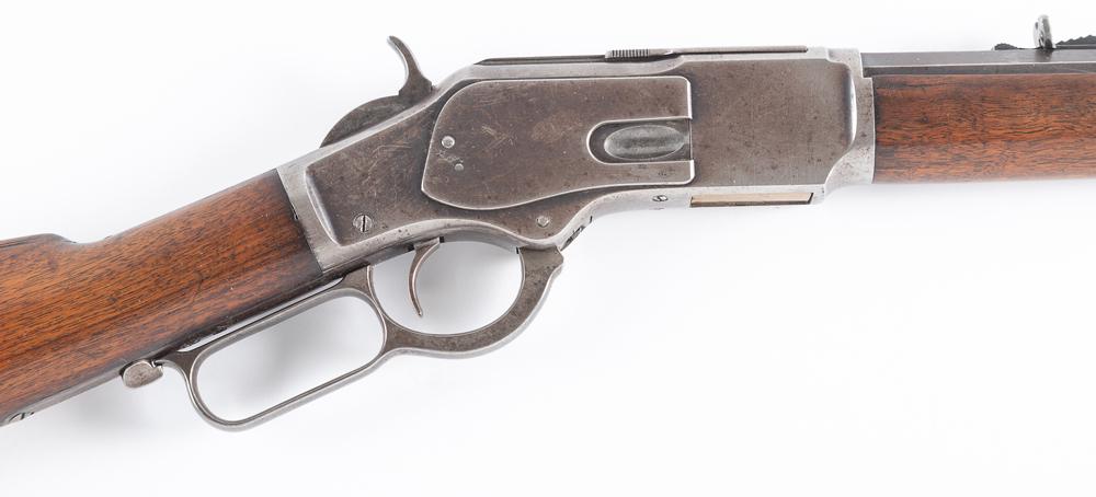 Winchester, Model 1873 Rifle, SN 584698 in .38 WCF caliber aka .38/40. Manufactured in 1903, this is: Winchester, Model 1873 Rifle, SN 584698 in .38 WCF caliber aka .38/40. Manufactured in 1903, this is astandard rifle with a 24” octagon barrel and full magazine tube. The dust cover remains inta