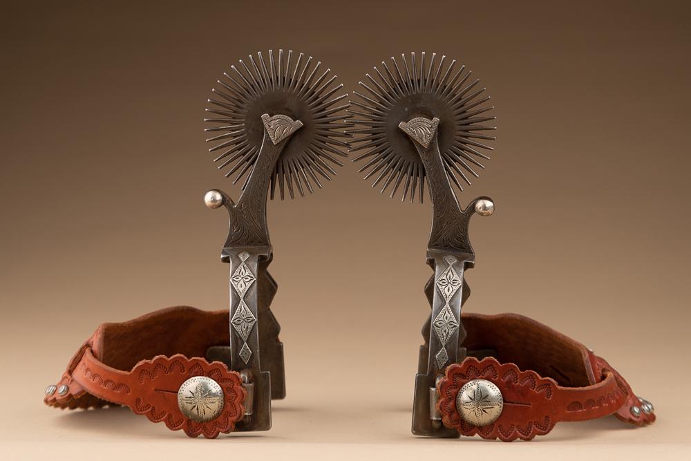 Pair of showy double mounted Spurs made by noted West Bountiful, Utah Bit & Spur Makers Lytle &: Pair of showy double mounted Spurs made by noted West Bountiful, Utah Bit & Spur Makers Lytle & Mower, hand engraved in diamond and heart pattern with 3" multi-point rowels. NOTE: Even the shanks are 