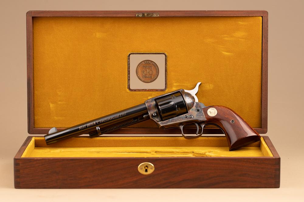 As new condition cased Colt, SAA Revolver, .45 caliber, SN NRA370. Hundred year NRA Sentential.: As new condition cased Colt, SAA Revolver, .45 caliber, SN NRA370. Hundred year NRA Sentential. Unfired condition, 7 1/2" barrel, blue finish with case hardened frame. Two piece wooden grips with gold