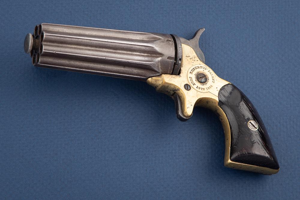 Antique Rupertus Pepperbox Derringer in .22 caliber. This revolving pepperbox, SN 1786, was: Antique Rupertus Pepperbox Derringer in .22 caliber. This revolving pepperbox, SN 1786, wasmanufactured circa 1860s in quantities totaling about 3000. The barrel consists of a fluted 8-shotcylinder wi